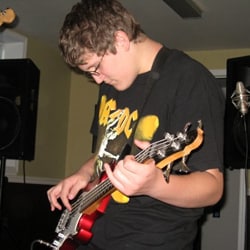 Gregory playing bass guitar