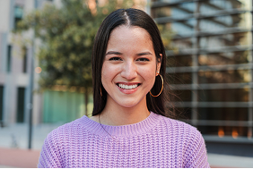 Smiling high school student in a purple sweater