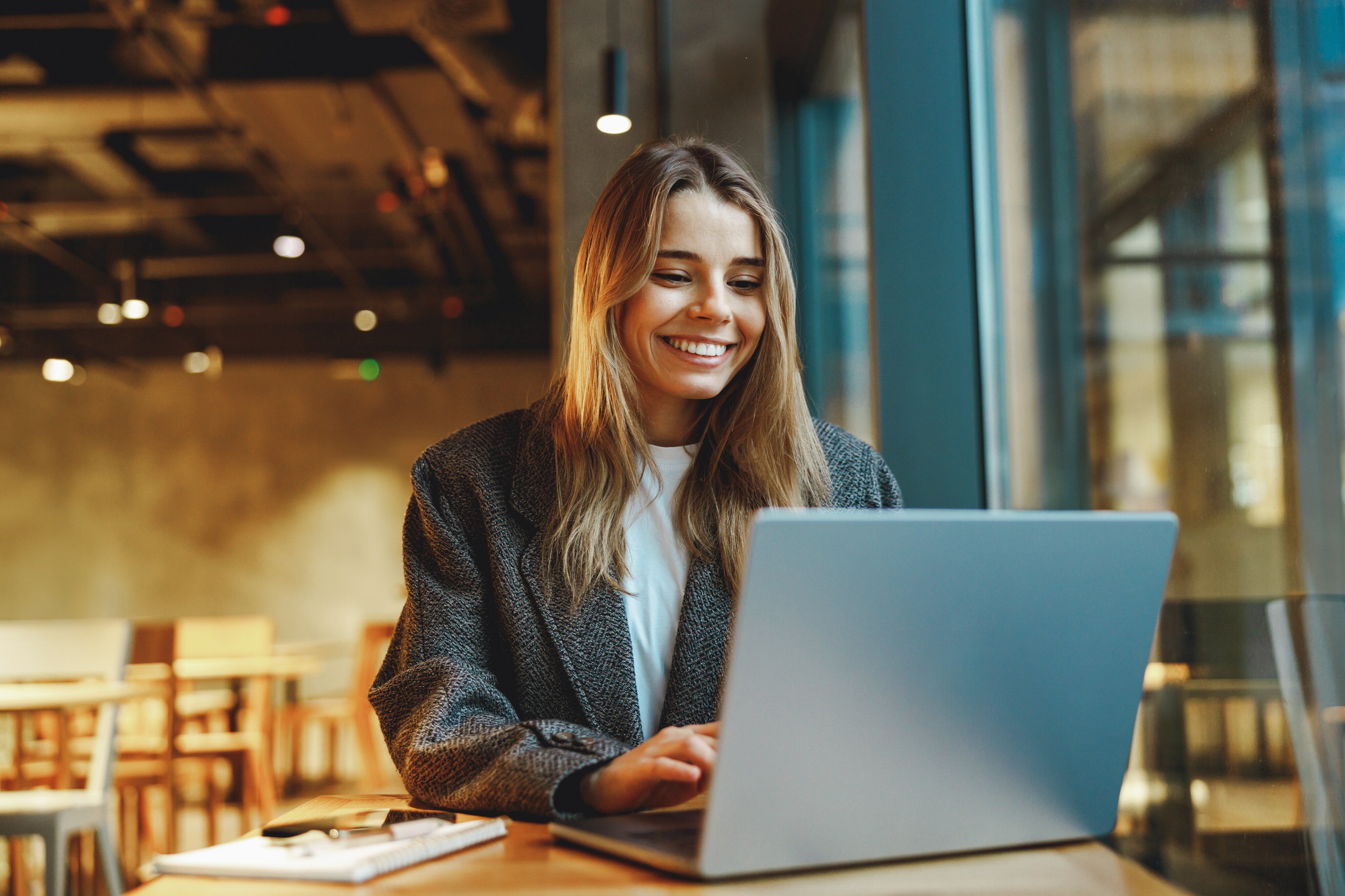 A young girl is sitting with laptop