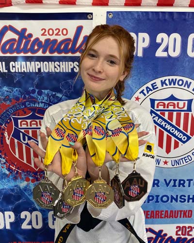 Emma wins a multitude of medals at her Taekwondo competion. 