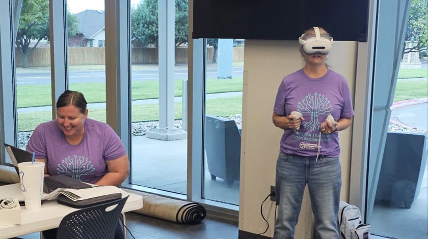 A teacher demonstrating how to use a VR headset