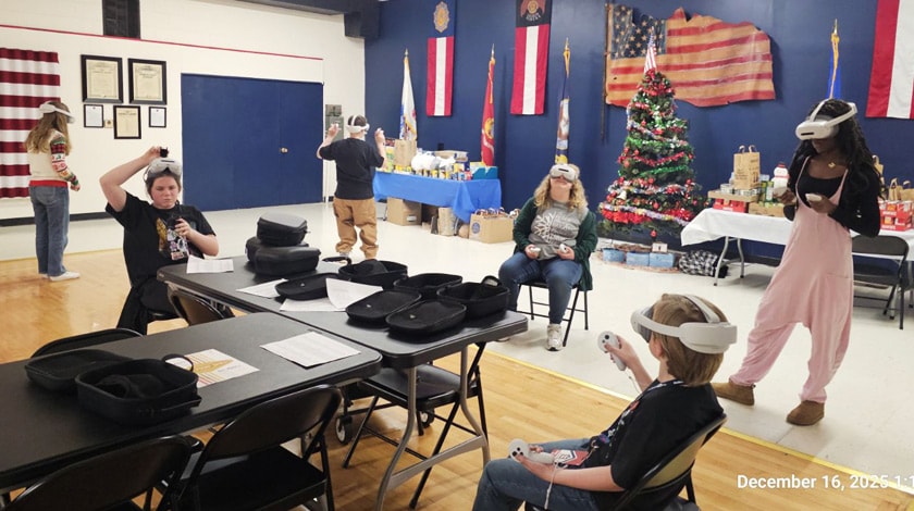 A group of students wearing VR headsets together