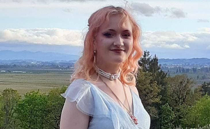 Image of Arayah from Willamette Connections Academy smiling with a white dress. 