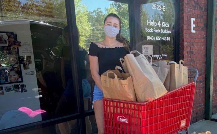Giana delivering groceries while volunteering.