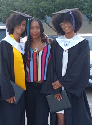 Image of Jada and Jalah D in their graduation gowns pictured alongside their mom.
