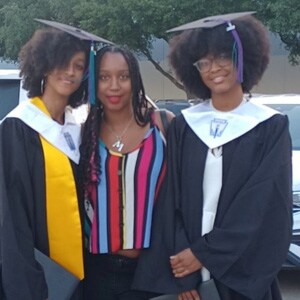 Image of Jada and Jalah D in their graduation gowns.