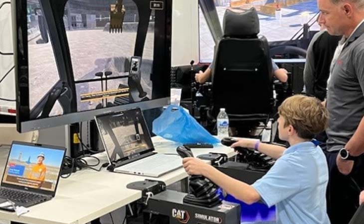 Conner from from Utah Connections Academy at a tech expo working on a video game.