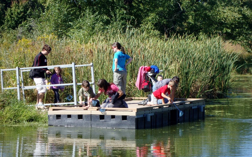 Students gather samples from a pond at Aldo Leopold Nature Center