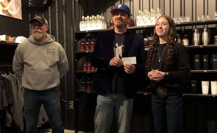 Jaidyn from Wyoming Connections Academy at a Farm to Table restaurant being presented an award.