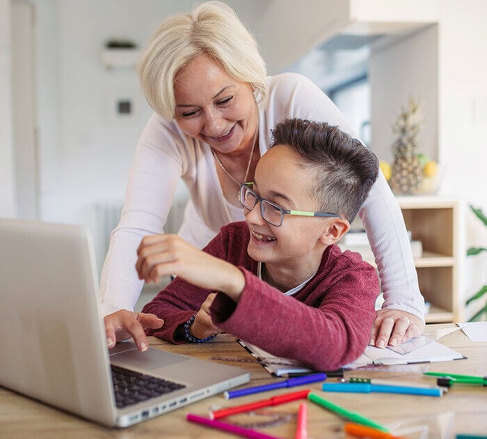 Mother and son studying together on a laptop - Connections Academy