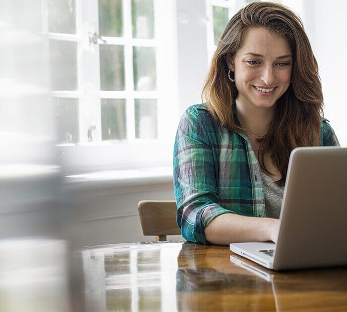 Parent attends virtual information session on computer - Connections Academy