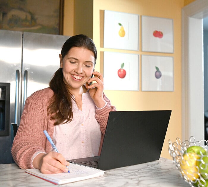 Parent speaks with online school technology support on the phone - Connections Academy