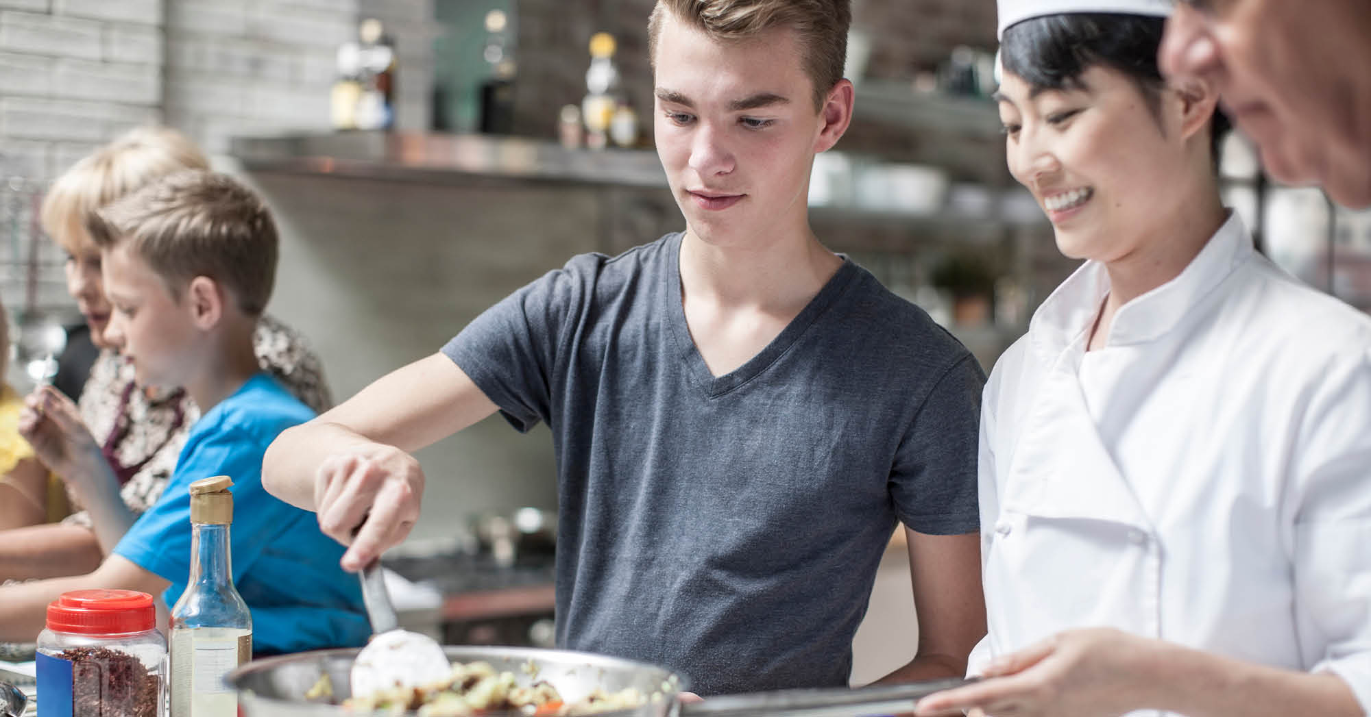 Caucasion male high school student learning how to cook - Connections Academy