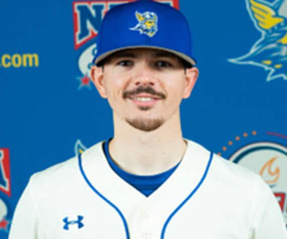 Connor graduate in baseball uniform smiling at camera