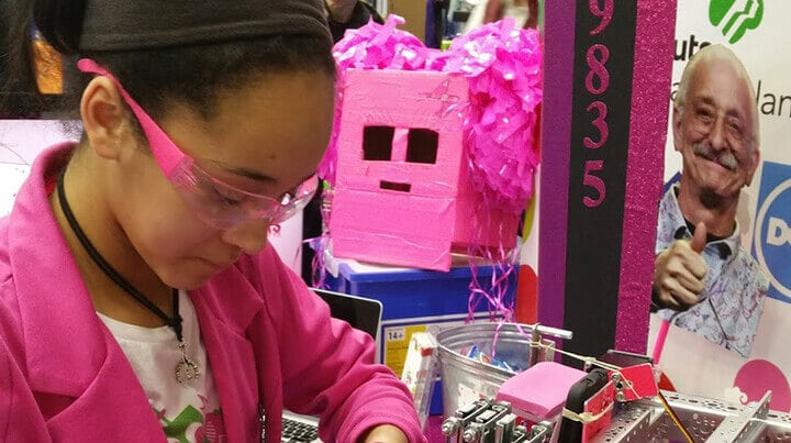 Madison wearing safety glasses and working on robotics project