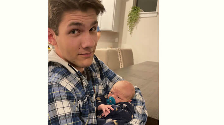 Neil holding his baby