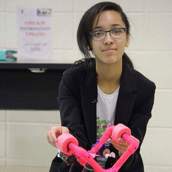 Image of Madison holding a robot she built