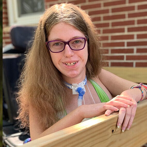 Image of Sarah smiling while on her deck