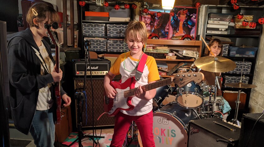 Oskar playing his guitar with his band