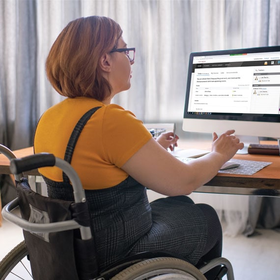 Caucasian female learning coach in wheelchair working at computer - Connections Academy
