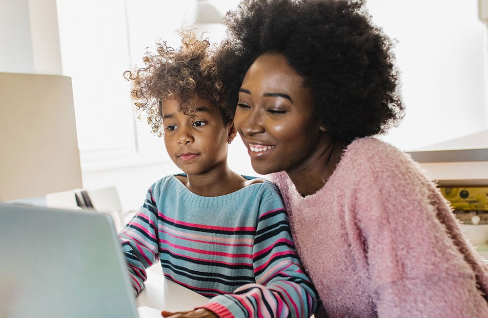 Mother and daughter participating in online learning