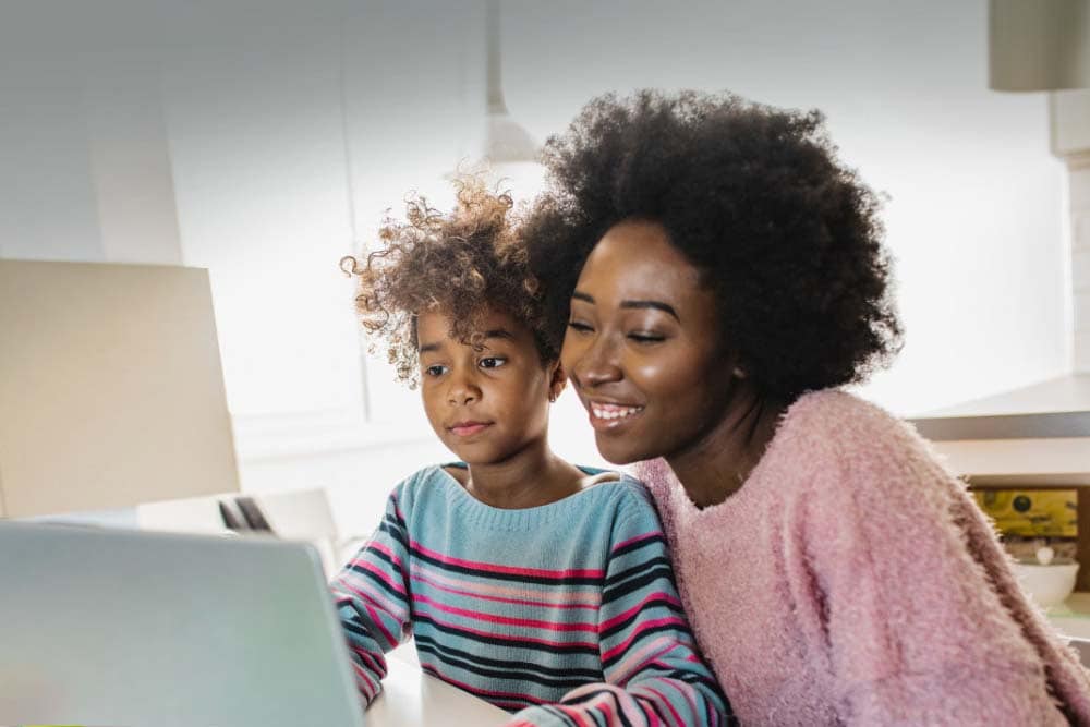 Mother and daughter participating in online learning