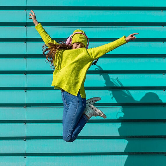 A teenage girl jumping in the air