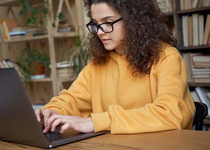 Parent helping his daughter with online school course on computer - Connections Academy