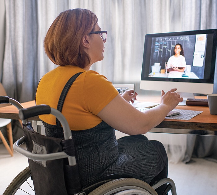 Parent in a wheel chair on the computer  - Connections Academy