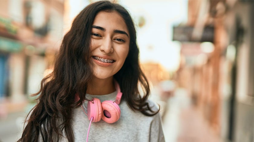 An online high school student smiling