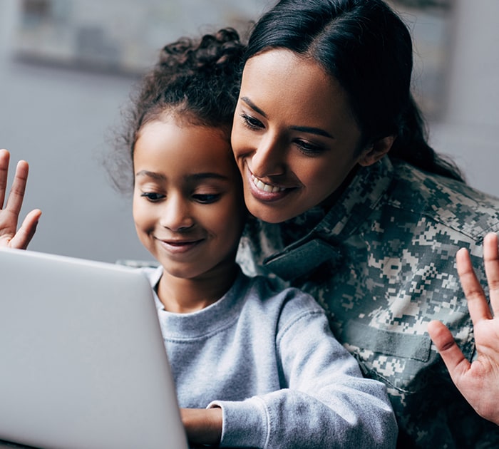A Connections Academy student and their military learning coach look up resources on a computer