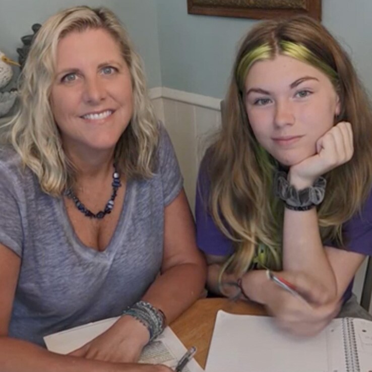 A photo of Ms. Kinney and her daughter smiling after studying for an online class together