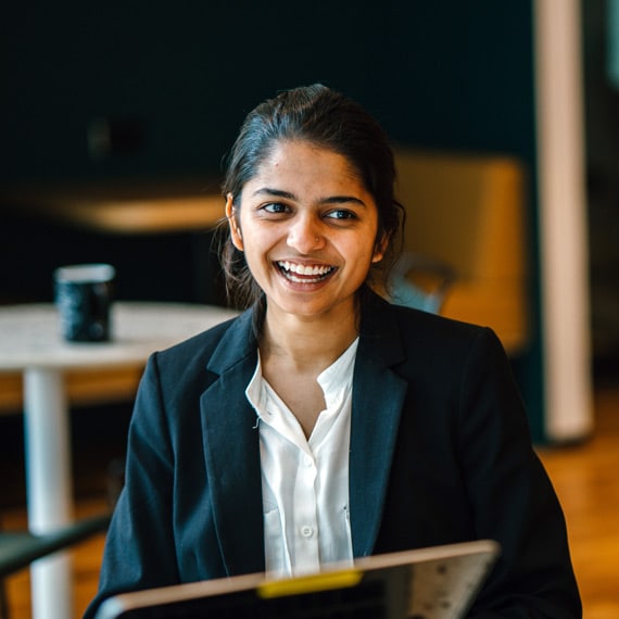 Professional young woman sitting at a table and smiling