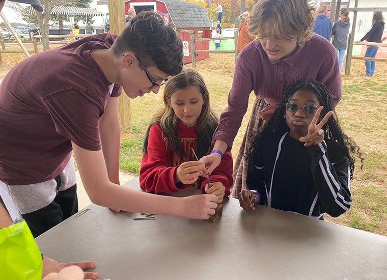 Students at the park doing a hands on science experiment.