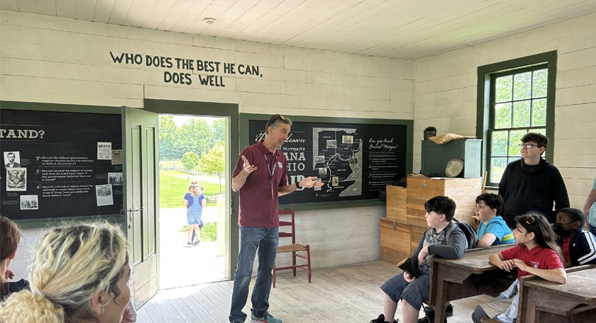A man speaking to a group of students at Connor Prairie.