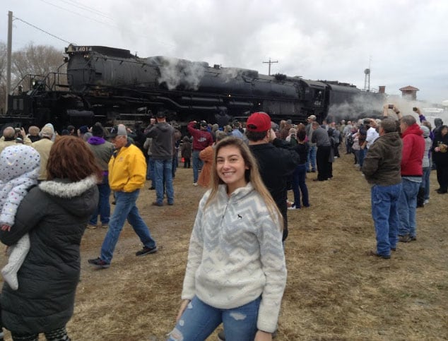 Kansas Connections Academy students smiling in front of a steam engine