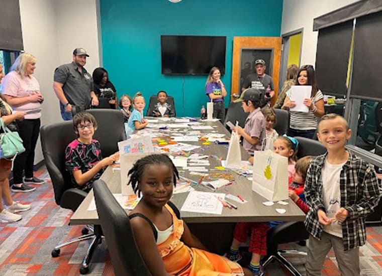 Students from Lowcountry Connections Academy gathered around a table doing an arts and crafts project together