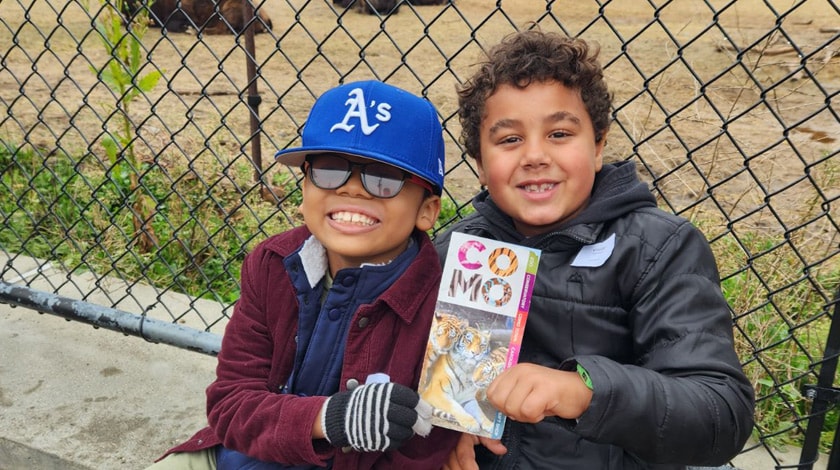 Minnesota Connections Academy students on a Como Zoo field trip and holding up a brochure