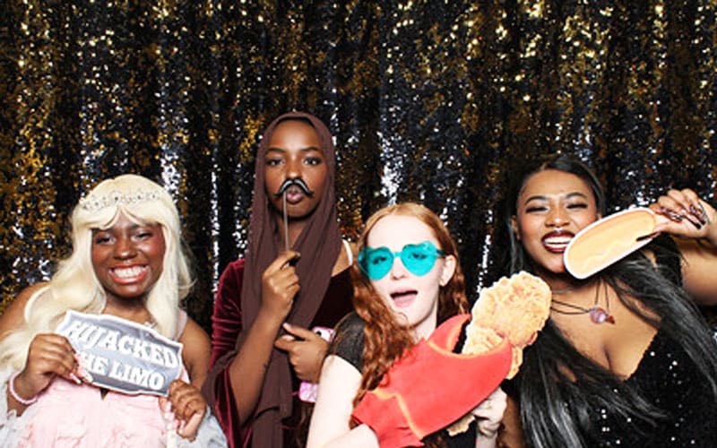 Students having fun at the prom photo station with props!
