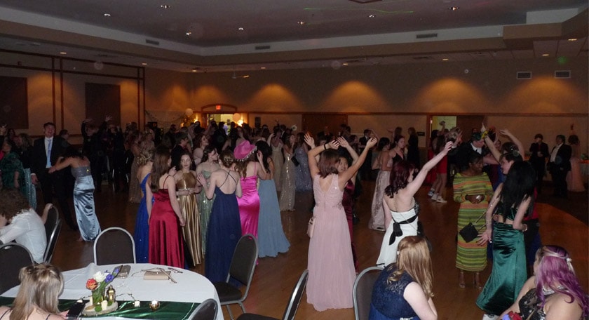 Students celebrating and dancing together on the prom dance floor!