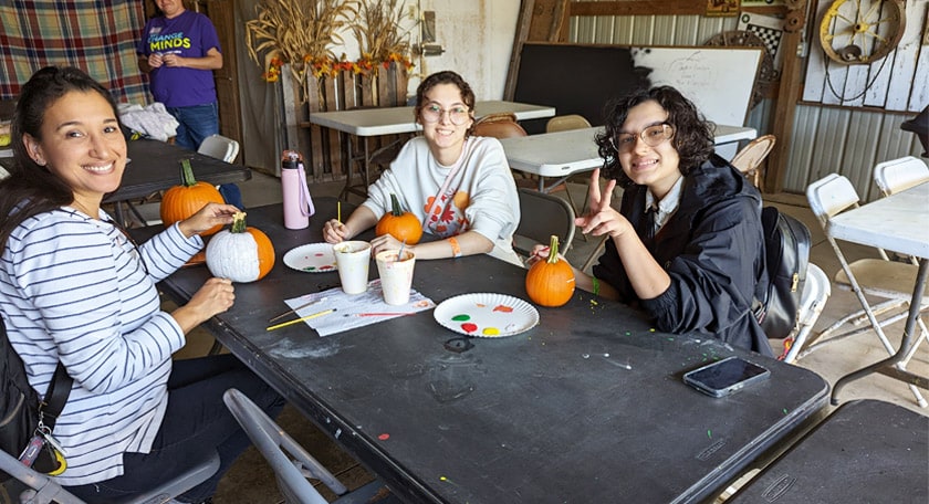 Students visit a pumpkin patch and participate in various activities such as pumpkin painting.