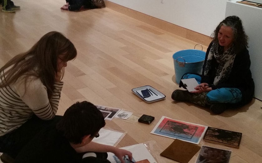 Harwood Art Museum visitors sitting on the floor looking at art