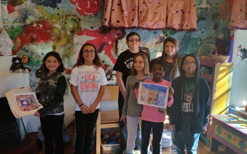 Students at New Mexico Connections Academy showing their artwork made at the Harwood Art Museum in Taos, NM