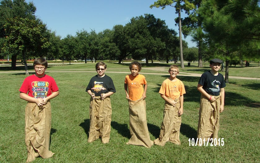 Five students are about to begin a sac race