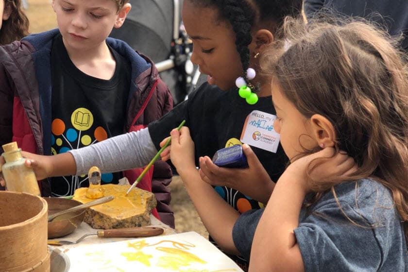 Students learning to write with feather quills