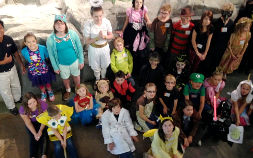 Students visit the Dinosaur museum in their Halloween costumes