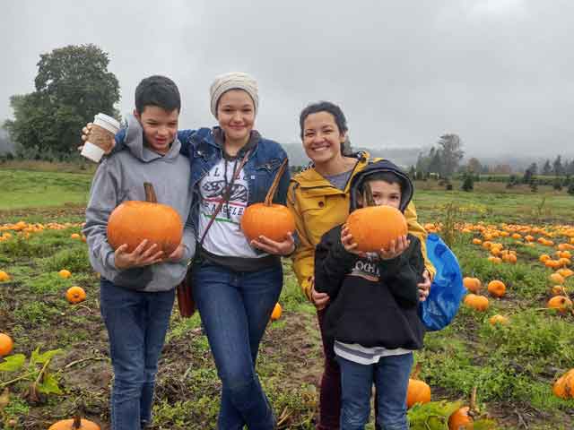 Families pick pumpkins at the Schilter Family Farm.