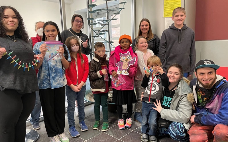 Students and families holding DNA models they created.