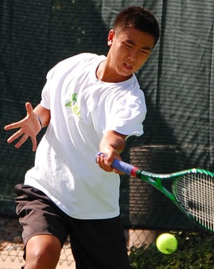 Augustus hitting a tennis ball 