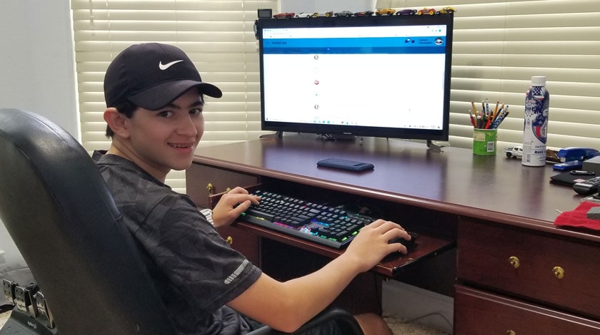 Carson doing schoolwork at his desk